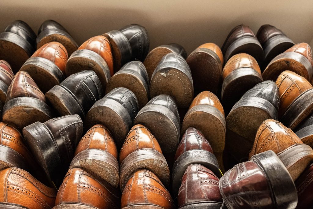 bedos leatherworks in falls church, va with stacks of shoes for repair