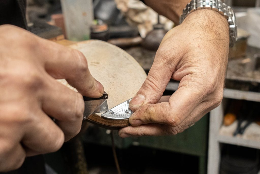 aligning toe taps on bottom of leather sole to make a cut